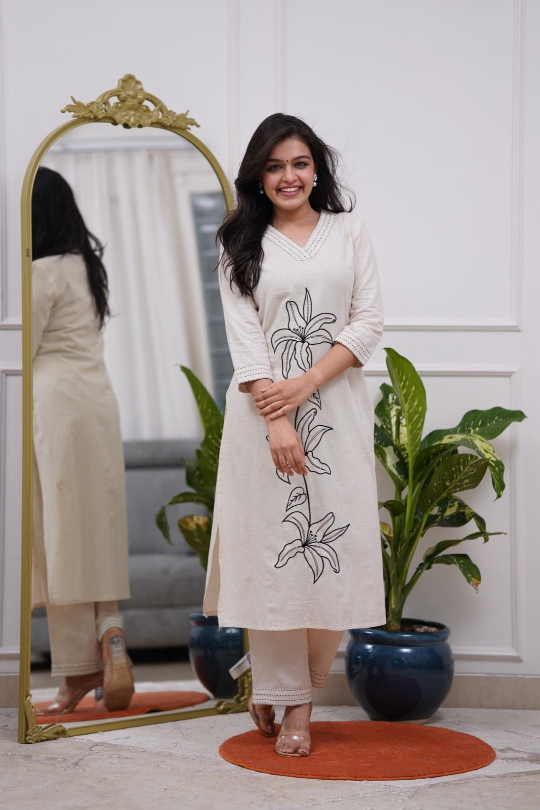 Woman wearing a white dress with black floral embroidery in a co-ord set - Vastra Gehna